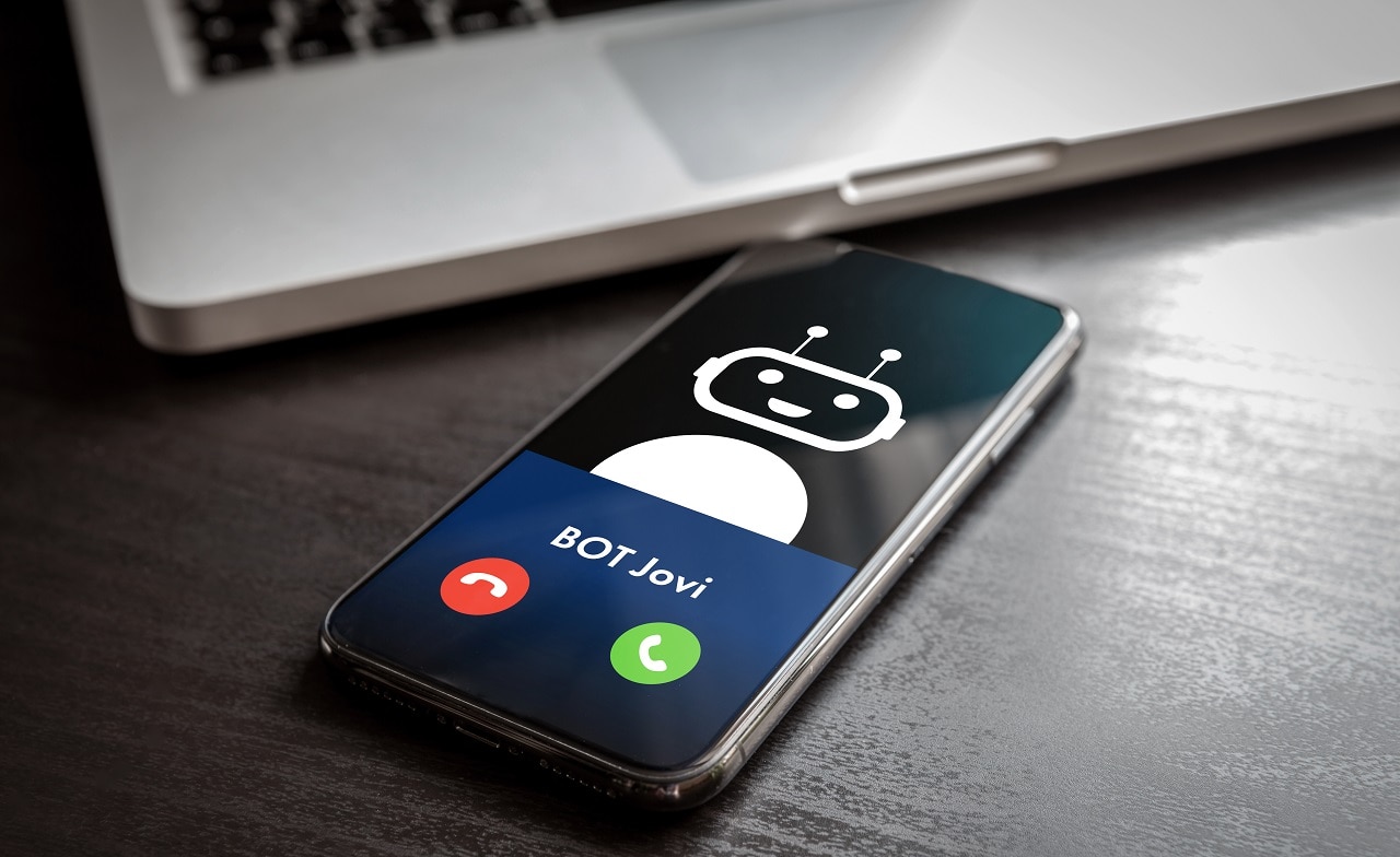 Chatbot on mobile phone screen on desk