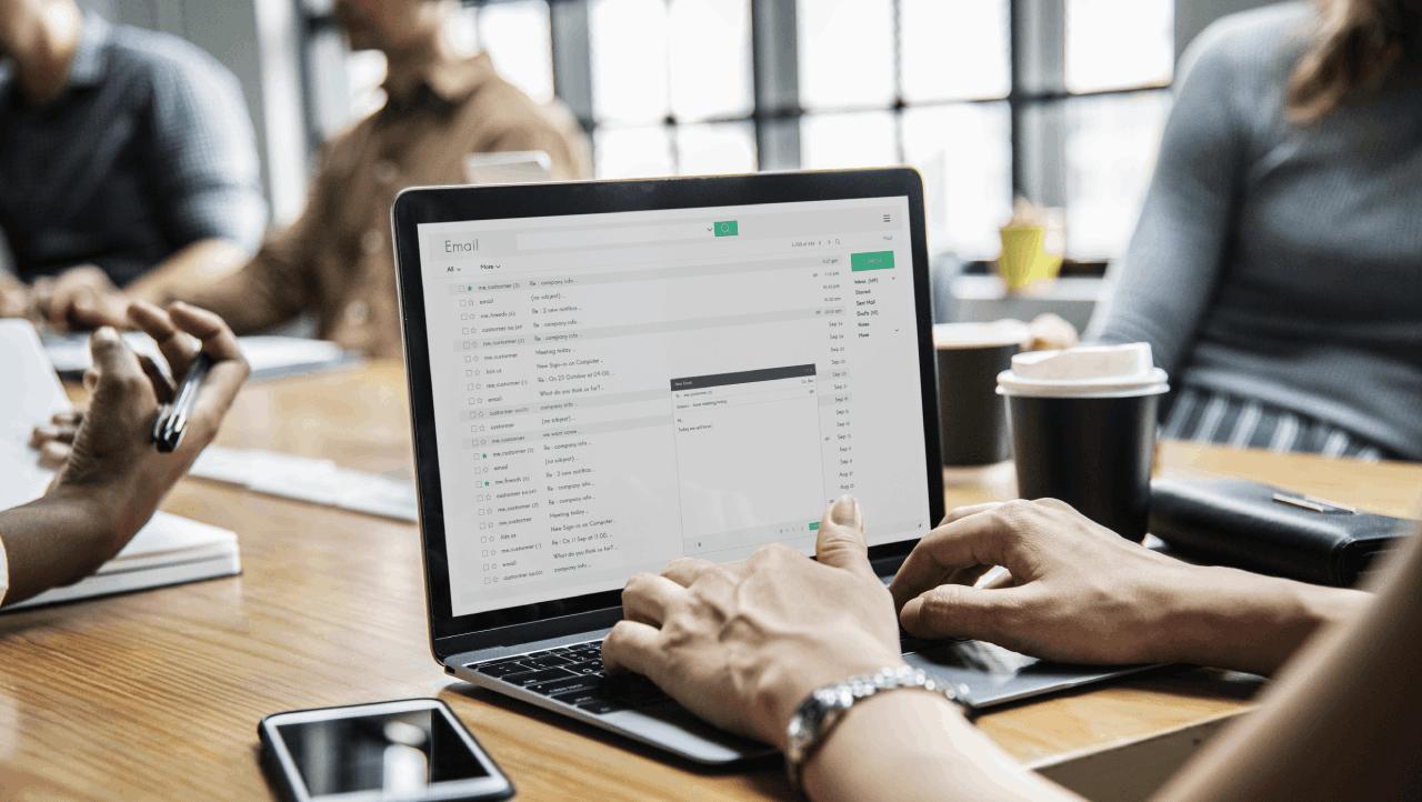 hands on keyboard in room with other coworkers