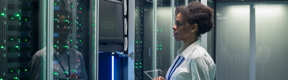 engineer standing in front of computers