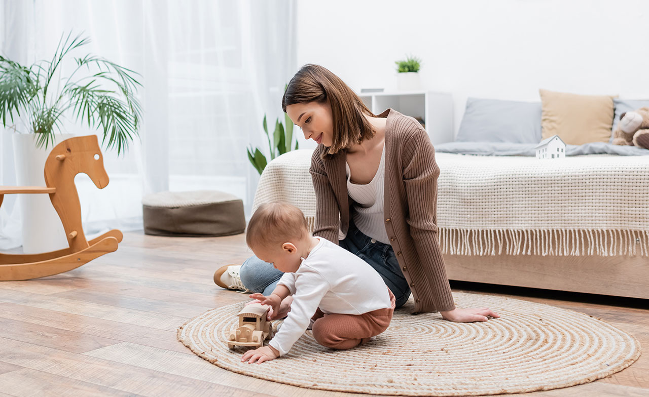Mother sitting on floor with a baby