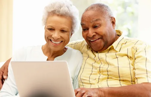elderly couple using laptop