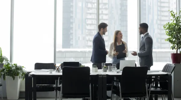 colleagues standing around a table
