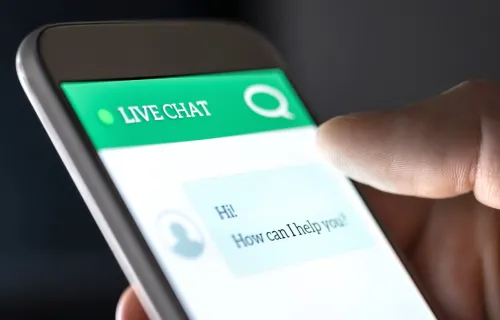 Hand holding mobile phone using chatbot