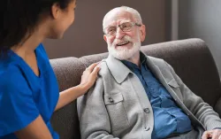 Healthcare professional talking to elderly patient