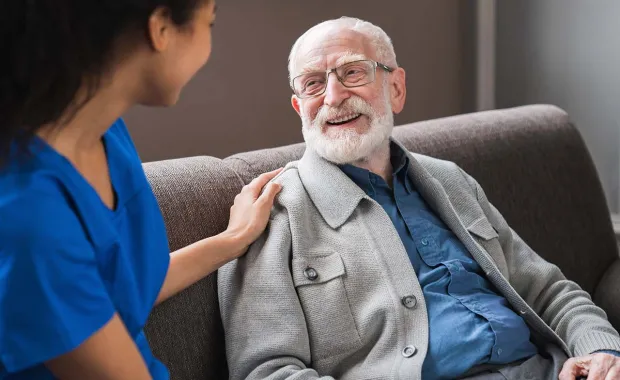 Healthcare professional talking to elderly patient