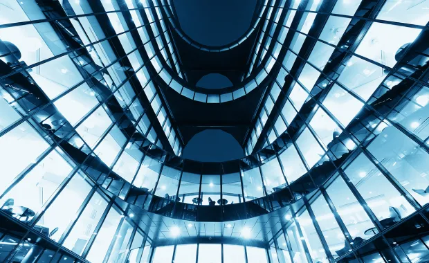 upward view of interior of multi-level office building with windows 