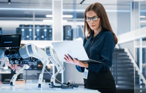 IT programmer working on computer in data center system control room
