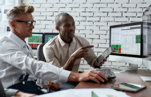 Two adults reviewing financial reports in an office