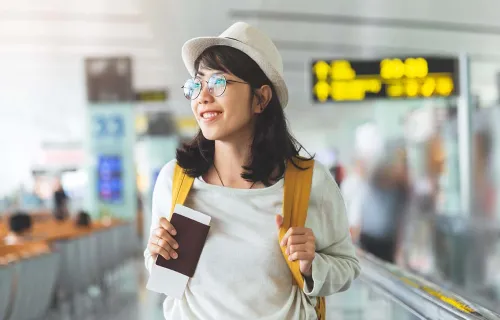 Person carrying a backpack and passport