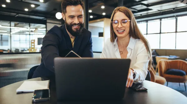 Two professionals looking at laptop