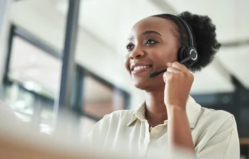 Smiling service desk worker in headset