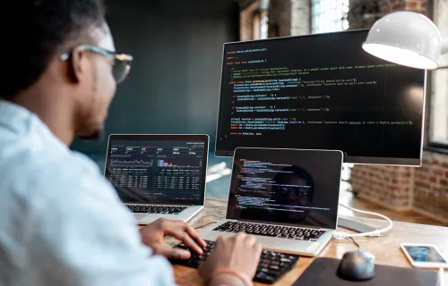 person coding on a computer