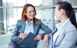 Two female consultants discussing their project