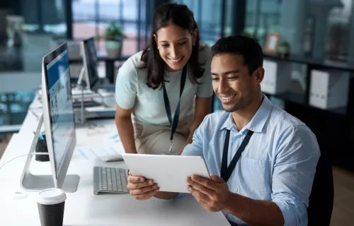 professionals working together looking at a tablet