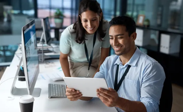 professionals working together looking at a tablet