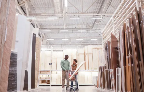 Wide angle of African American father and son shopping in hardware store