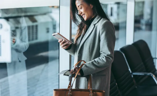 woman holding phone in metro station